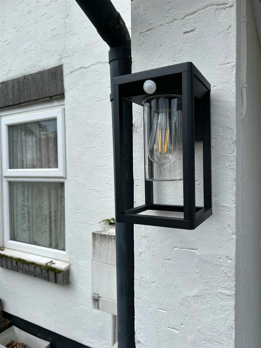 Modern black outdoor light fitted to an exterior wall